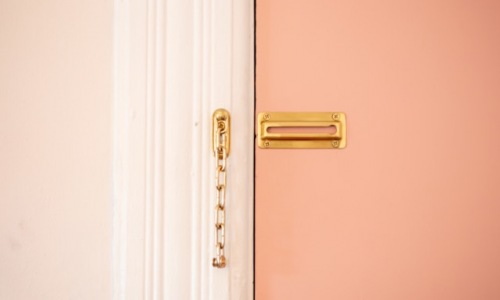 brown door lock on a pink door